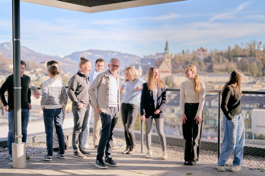 Team on the rooftop terrace enjoying the view over Salzburg
