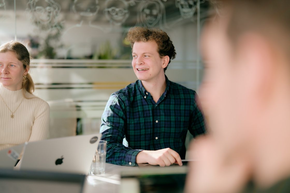 Employee laughing during team meeting